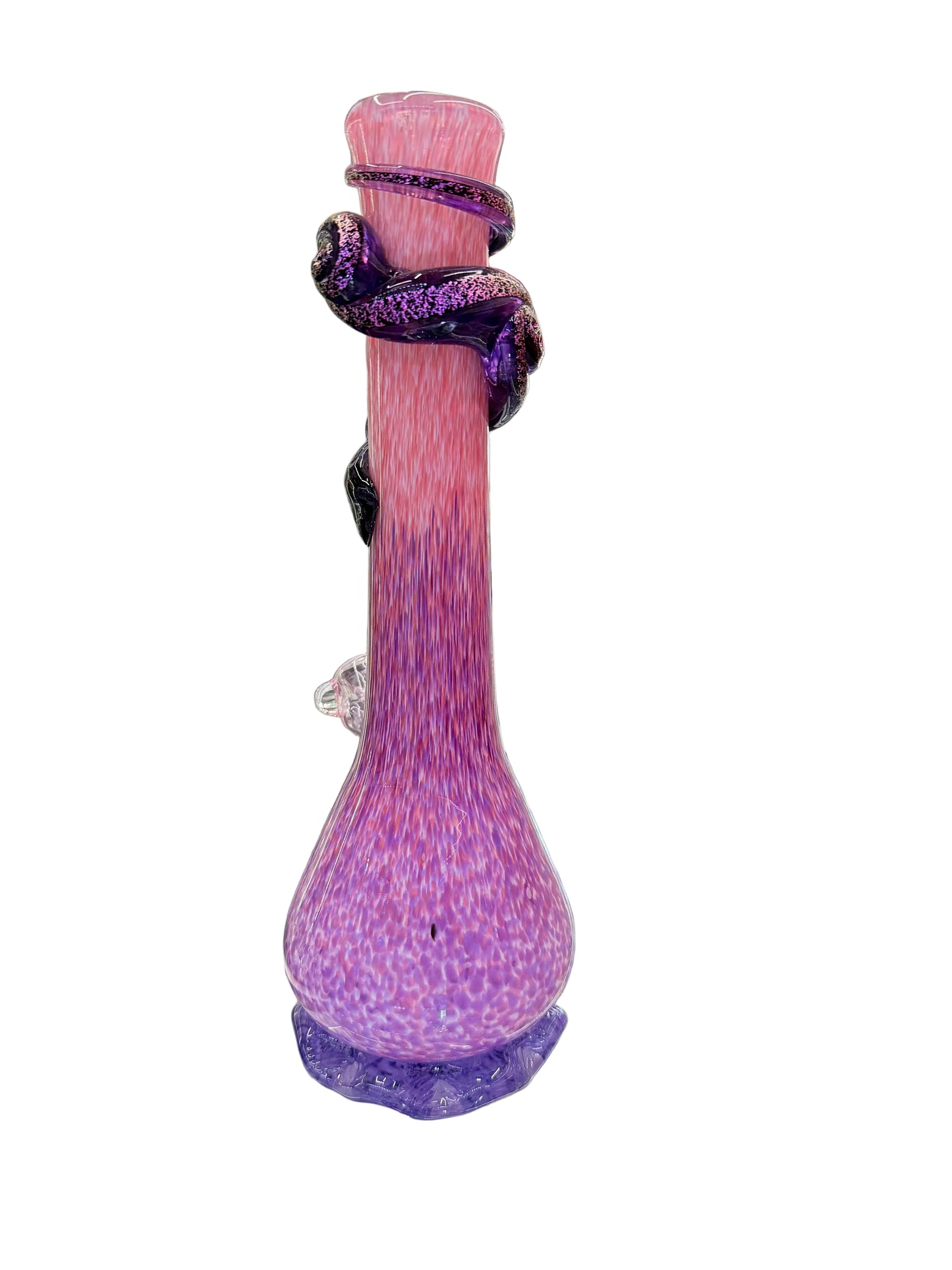 Pink and purple glass pipe on a shelf in a store with colorful items in the background