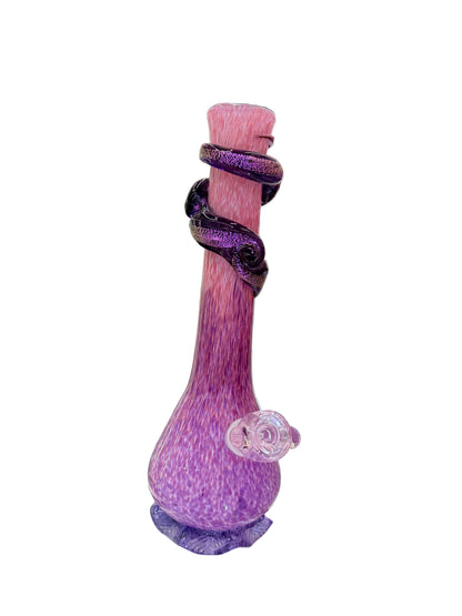 Purple glass pipe with purple ribbons on a shelf in a store